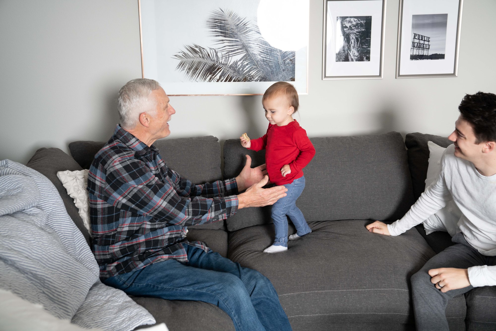 toddler taking first steps towards grandpa 1